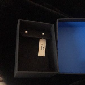 Tiny white imitation pearl earrings in blue box.  Back posts are gold filled.